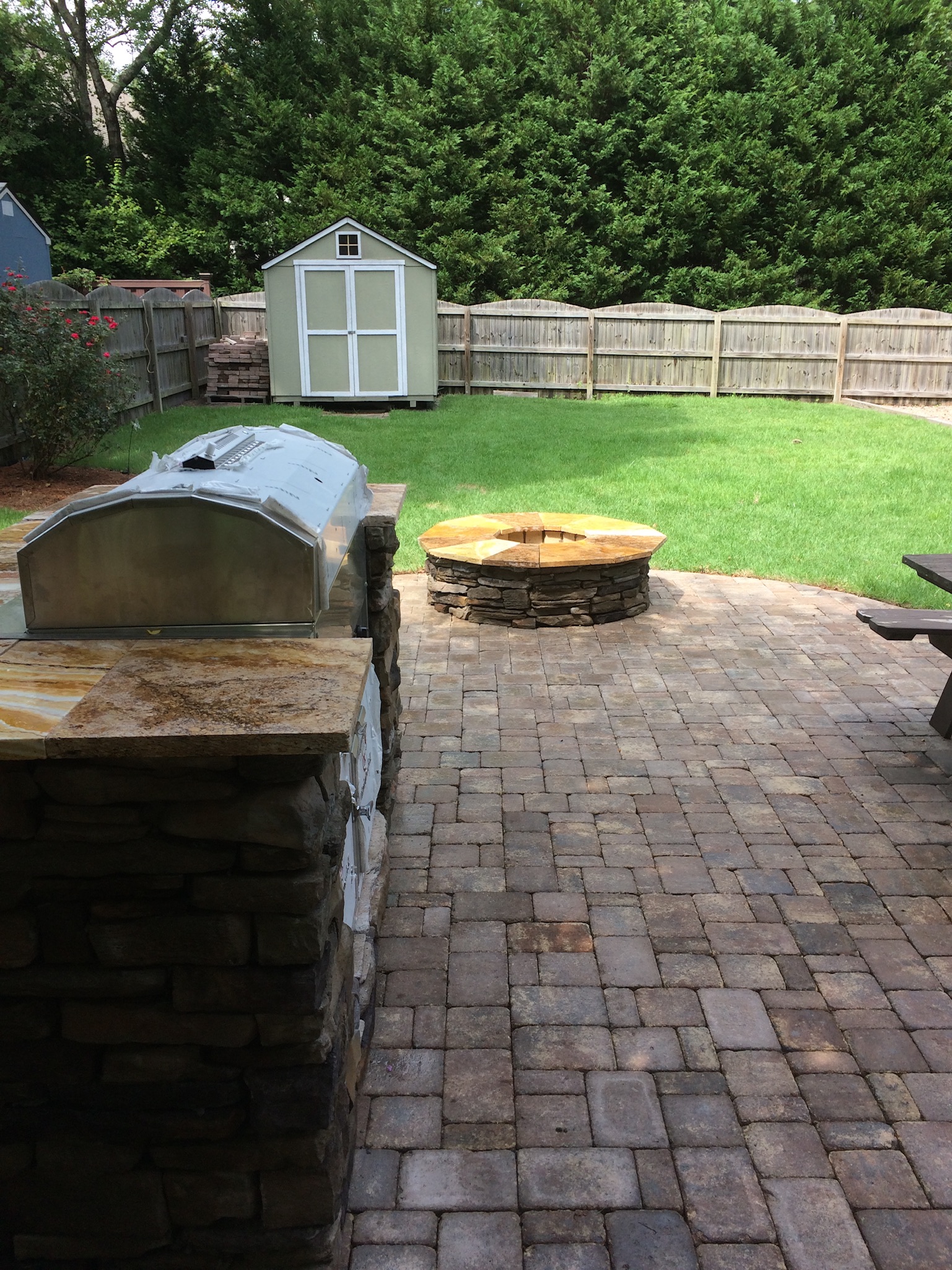 golden fire pit and stone grill